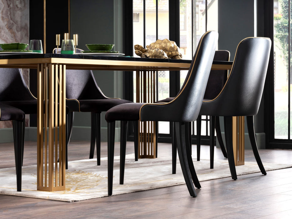 The Carlino Table designed for durability with a marble tempered finish and gold metal legs.