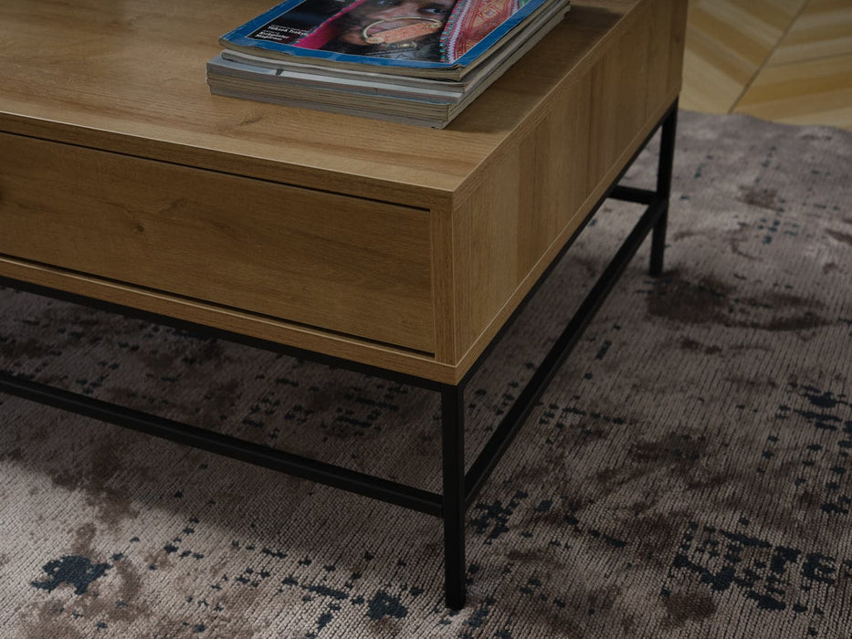 The Drift Coffee Tableâ€™s modern contrast of wood and metal adds visual interest to any room.