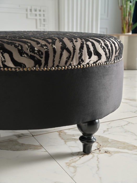 Comfortable Gaze Round Ottoman filled with premium-grade cushioning for relaxation.