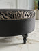 Comfortable Gaze Round Ottoman filled with premium-grade cushioning for relaxation.